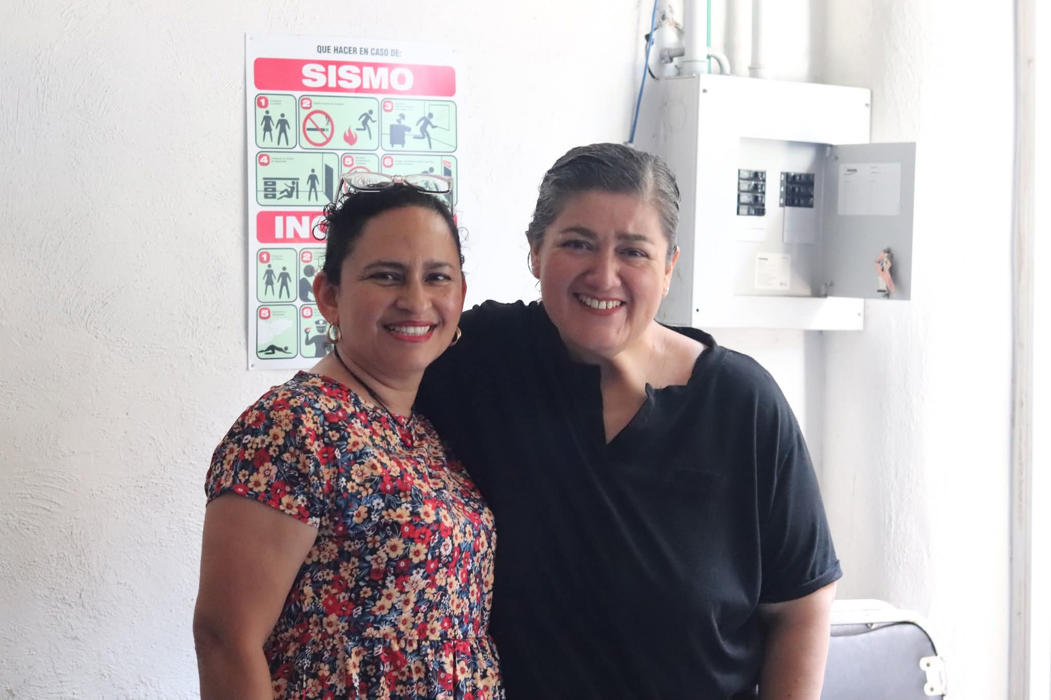 Mujer riendo y compartiendo en una mesa